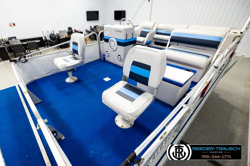 Slide: The Image of 1994 Hydra 192-23 boat interior with blue and white seating, showcased indoors. - 10