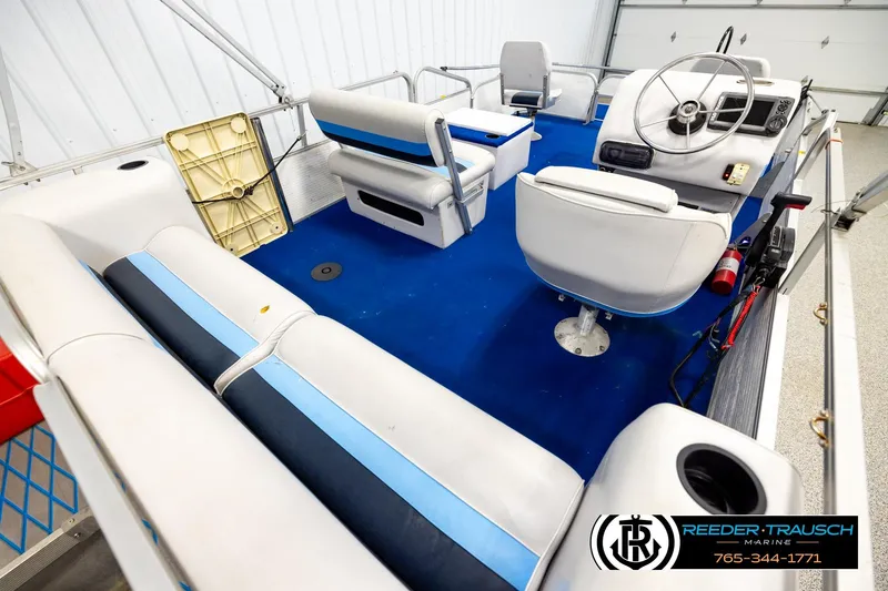Slide: The Image of Interior of a 1994 Hydra 192-23 boat with blue and white seating. - 12