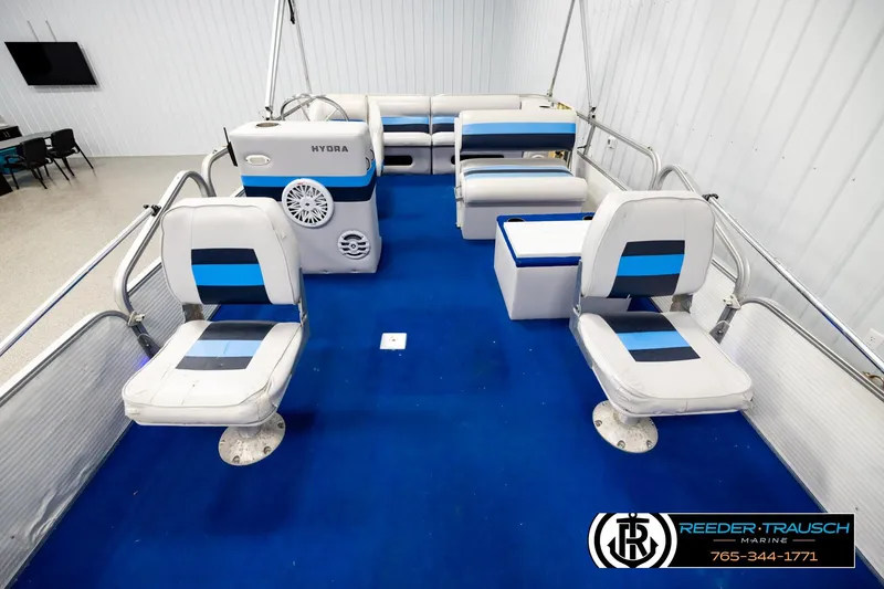 Slide: The Image of Interior of a 1994 Hydra 192-23 boat with blue and white seating. - 13