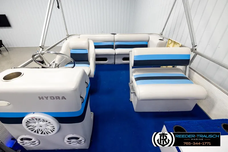 Slide: The Image of Interior of a 1994 Hydra 192-23 boat with blue and white seating. - 14