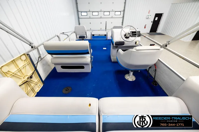 Slide: The Image of Interior of a 1994 Hydra 192-23 boat with blue carpet and seating. - 16