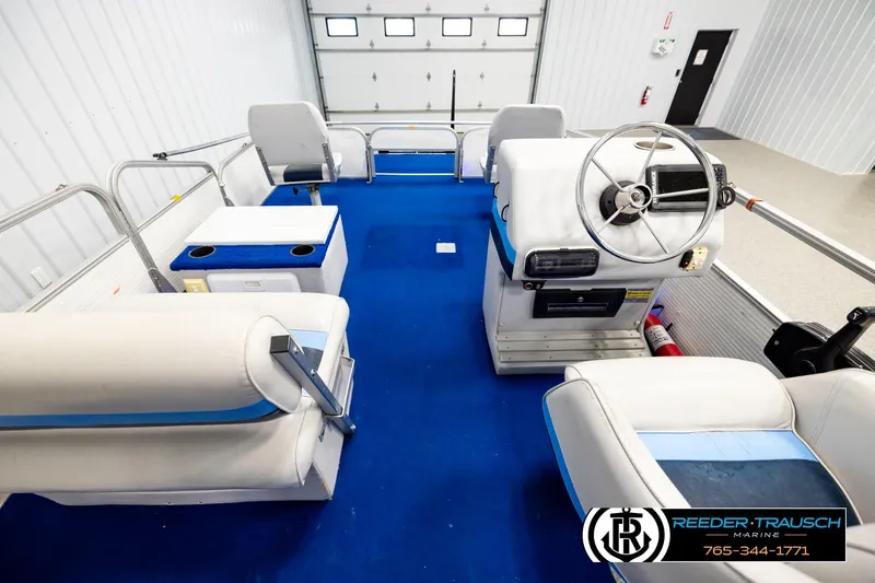 Slide: The Image of Interior of a 1994 Hydra 192-23 boat with blue carpet and white seating. - 17
