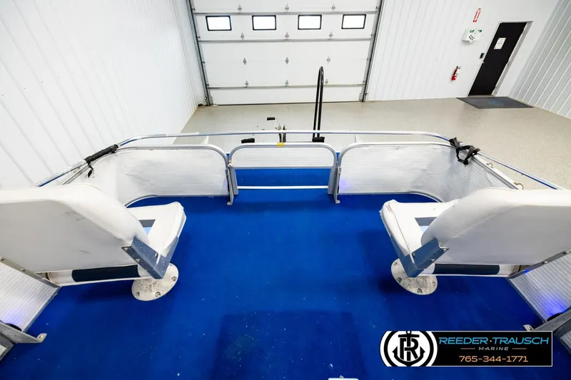Slide: The Image of Interior view of a 1994 Hydra 192-23 boat with blue carpet and white seating. - 18