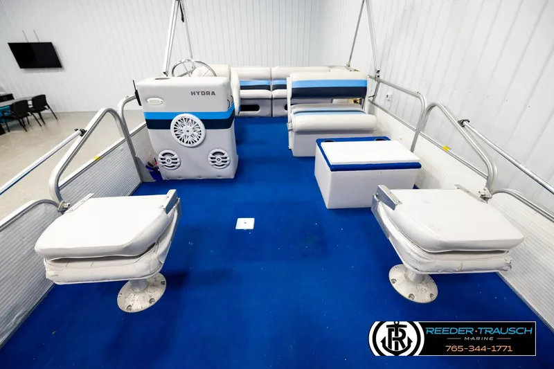 Slide: The Image of Interior of a 1994 Hydra 192-23 boat with blue carpet and white seating. - 19