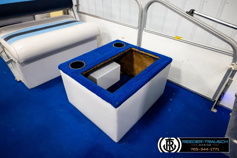 Slide: The Image of Interior of a 1994 Hydra 192-23 boat with blue carpeted storage box. - 25