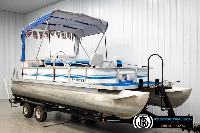 Slide: The Image of 1994 Hydra 192-23 pontoon boat on trailer in indoor storage facility. - 3