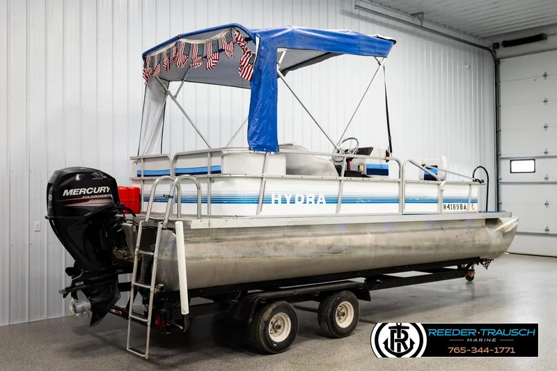 Slide: The Image of 1994 Hydra 192-23 pontoon boat with Mercury outboard motor in a garage setting. - 6