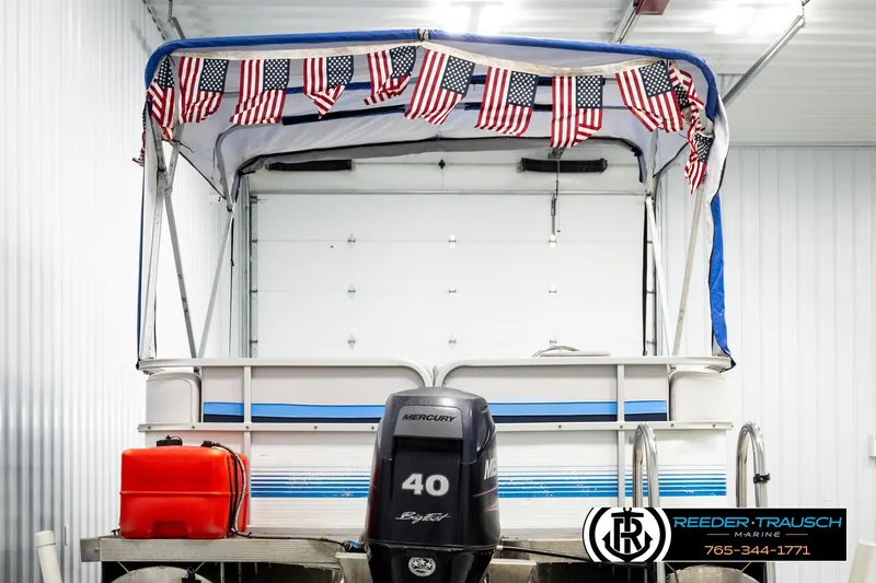 Slide: The Image of 1994 Hydra 192-23 boat with Mercury 40 engine, American flags, and Reeder-Trausch Marine branding. - 7