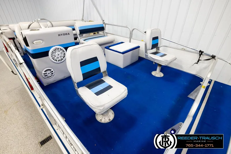 Slide: The Image of Interior of a 1994 Hydra 192-23 boat with blue and white seating. - 9