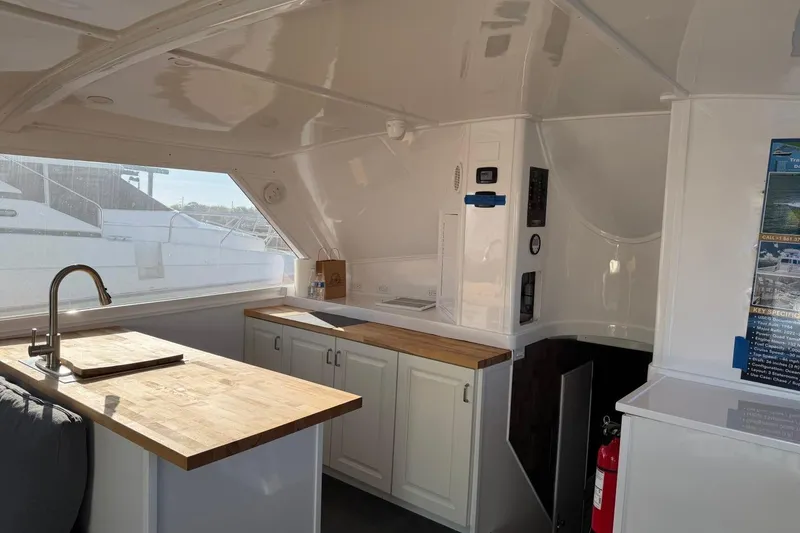 Slide: The Image of Interior of 1984 Ocean Yachts 55 Super Sport, featuring a modern kitchen with wooden countertops. - 25