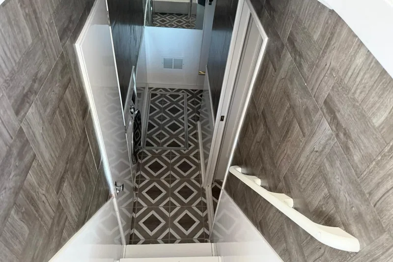 Slide: The Image of Interior hallway of 1984 Ocean Yachts 55 Super Sport with patterned flooring and wood paneling. - 26