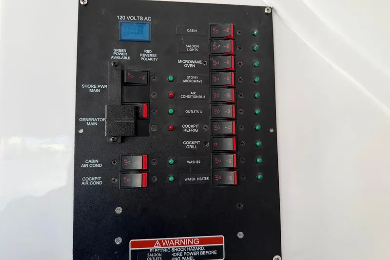 Slide: The Image of Electrical panel of 1984 Ocean Yachts 55 Super Sport, featuring various circuit breakers and switches. - 27