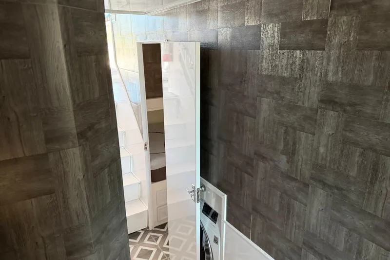 Slide: The Image of Interior of 1984 Ocean Yachts 55 Super Sport with modern wood paneling and geometric flooring. - 33