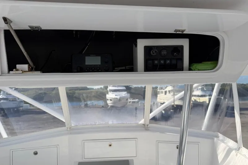 Slide: The Image of Interior view of 1984 Ocean Yachts 55 Super Sport with control panel and marina backdrop. - 42