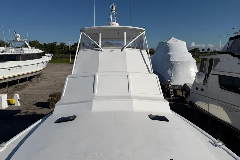 Slide: The Image of 1984 Ocean Yachts 55 Super Sport on dry dock, surrounded by other boats. - 47