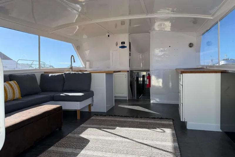 Slide: The Image of Luxurious interior of 1984 Ocean Yachts 55 Super Sport with modern seating and kitchen area. - 49