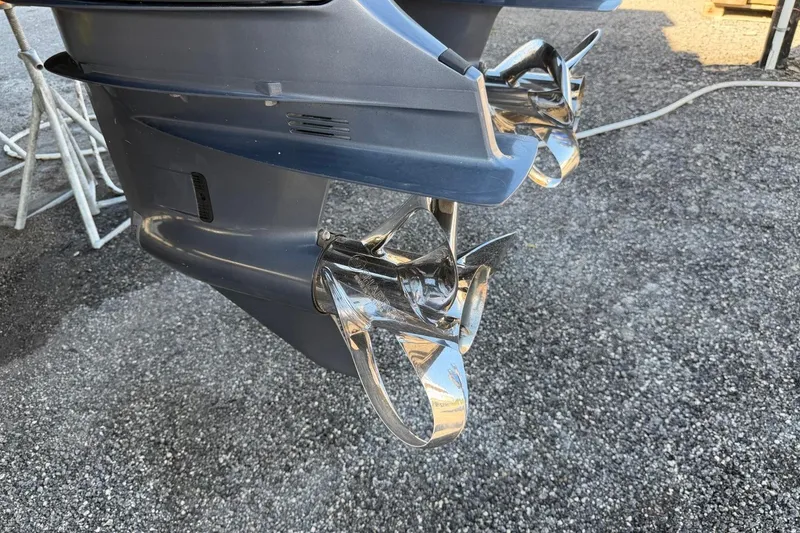 Slide: The Image of Propellers of a 1984 Ocean Yachts 55 Super Sport on gravel surface. - 54