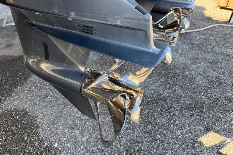 Slide: The Image of Close-up of Ocean Yachts 55 Super Sport 1984 boat propeller on gravel surface. - 56