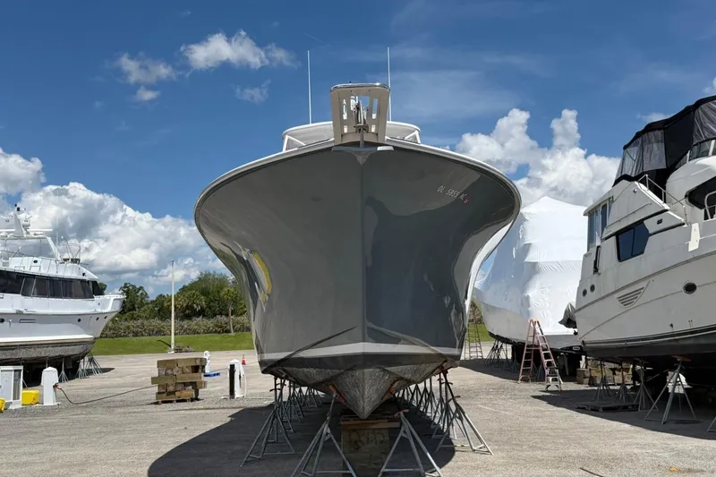 Slide: The Image of 1984 Ocean Yachts 55 Super Sport boat on stands, clear sky background. - 9