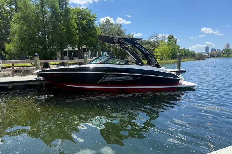 The Image of 2017 Regal 24 FasDeck boat docked on a sunny lake with city skyline. - 0