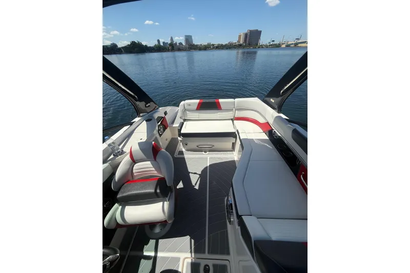 Slide: The Image of 2017 Regal 24 FasDeck boat interior with modern seating on a calm lake. - 2