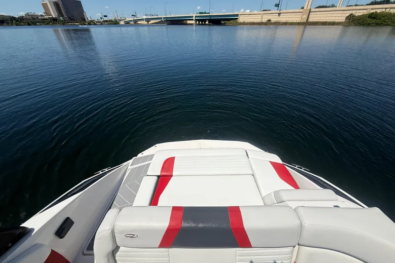 Slide: The Image of 2017 Regal 24 FasDeck boat on calm water near a bridge. - 3