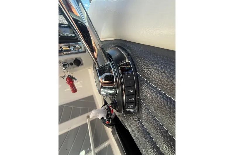 Slide: The Image of Close-up of 2017 Regal 24 FasDeck boat controls with leather trim and chrome accents. - 7