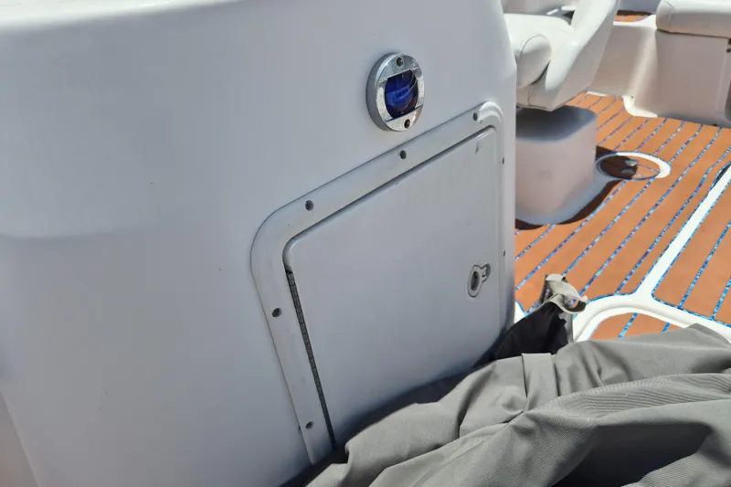 Slide: The Image of 2013 Hurricane FunDeck 226 boat interior with storage compartment and seating. - 15