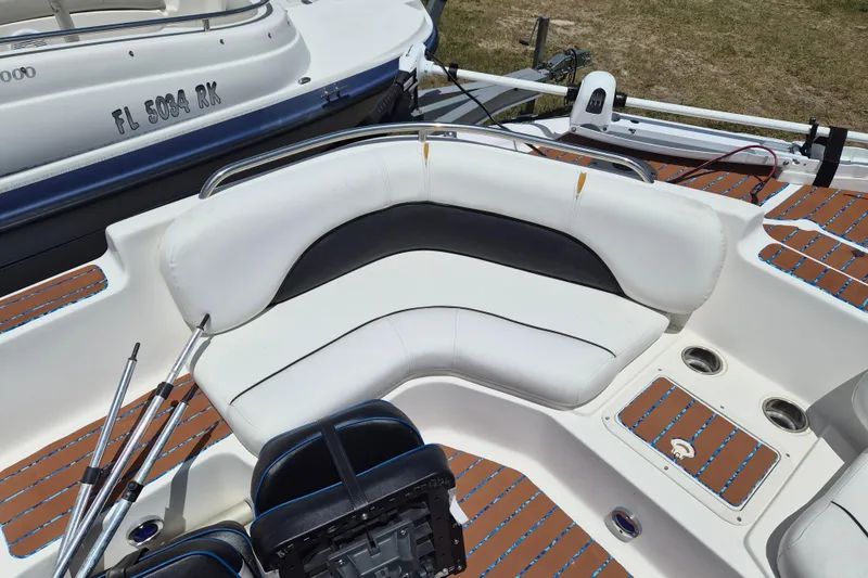 Slide: The Image of 2013 Hurricane FunDeck 226 boat interior with white seating and brown deck. - 16