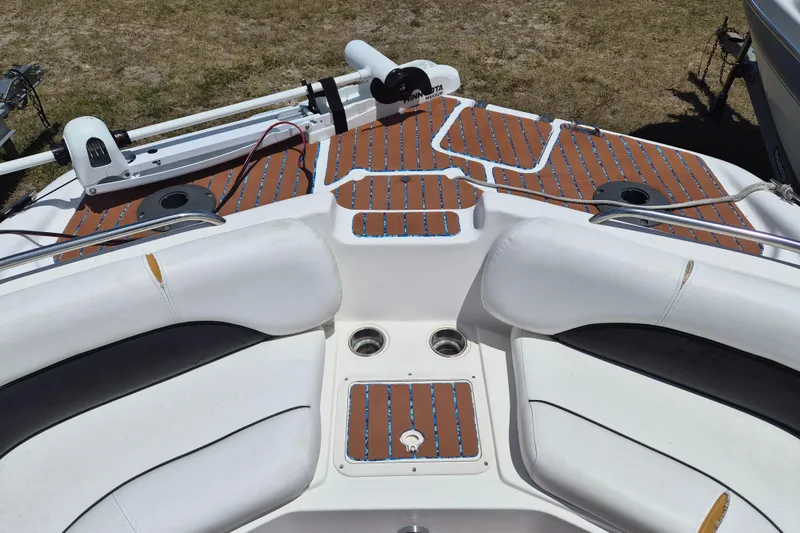 Slide: The Image of 2013 Hurricane FunDeck 226 boat interior with cushioned seating and wood-patterned flooring. - 17
