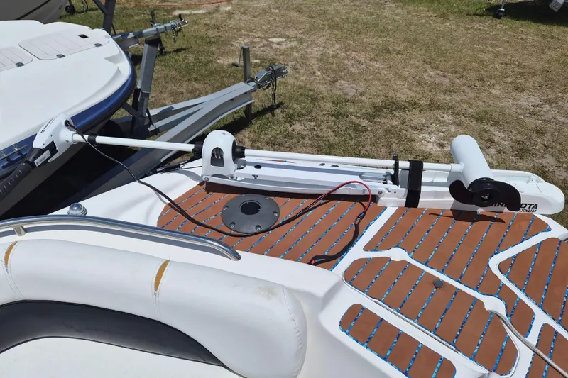 Slide: The Image of 2013 Hurricane FunDeck 226 boat with trolling motor on trailer, parked on grass. - 18