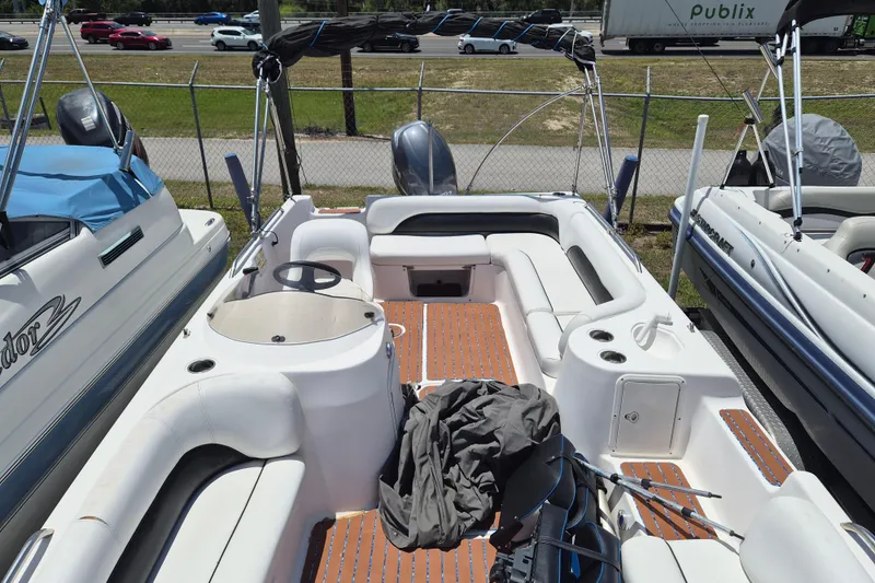 Slide: The Image of 2013 Hurricane FunDeck 226 boat with spacious seating and wood-patterned flooring. - 19