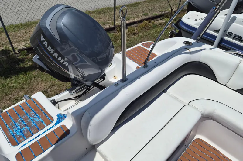 Slide: The Image of 2013 Hurricane FunDeck 226 boat with Yamaha outboard motor, white seating, and brown deck accents. - 7