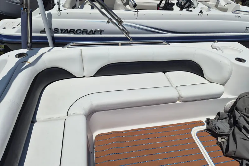 Slide: The Image of 2013 Hurricane FunDeck 226 boat interior with white seating and wood-patterned flooring. - 8