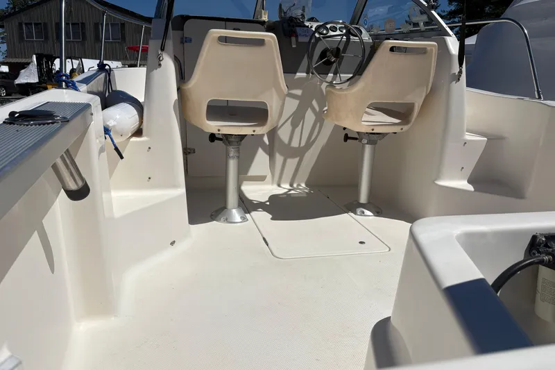 Slide: The Image of 2004 Trophy 1802 Walkaround boat interior with dual seats and steering wheel. - 13
