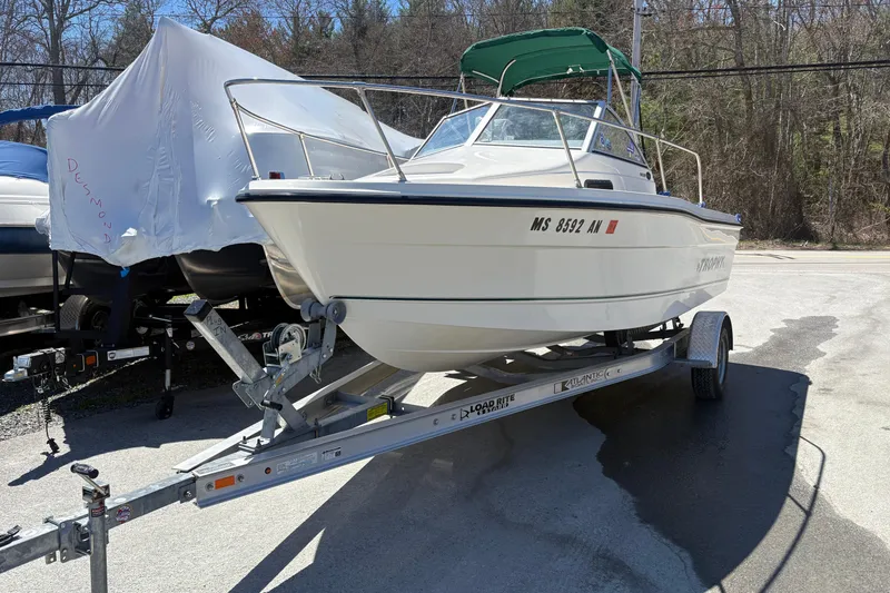 Slide: The Image of 2004 Trophy 1802 Walkaround boat on trailer, parked outdoors. - 2