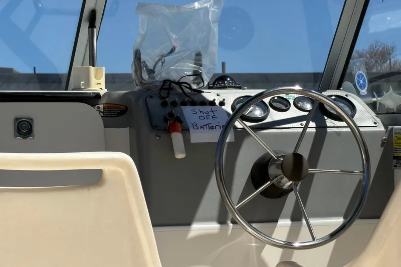 Slide: The Image of Steering wheel of a 2004 Trophy 1802 Walkaround boat with dashboard controls. - 7