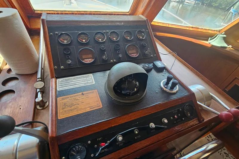 Slide: The Image of 1981 Sea Ranger 47 Pilothouse helm with gauges, compass, and controls. - 12