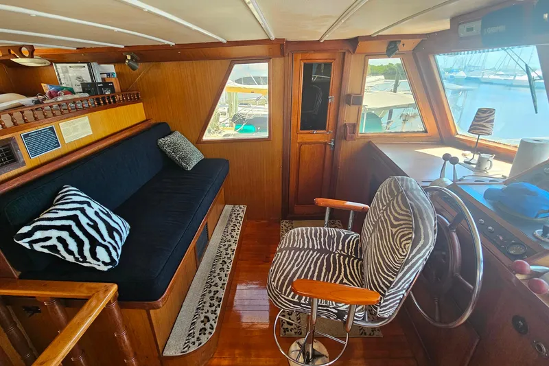 Slide: The Image of 1981 Sea Ranger 47 Pilothouse interior with zebra-patterned seating and wooden accents. - 13