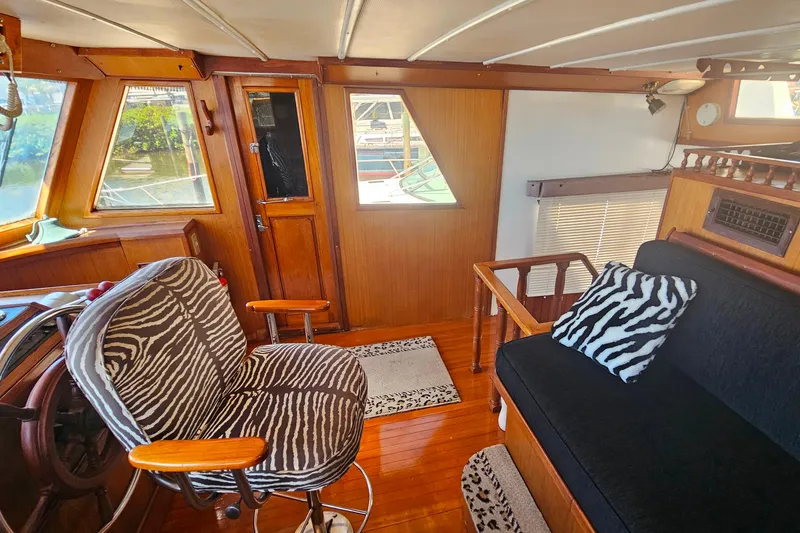 Slide: The Image of 1981 Sea Ranger 47 Pilothouse interior with zebra-patterned seating and wooden accents. - 15