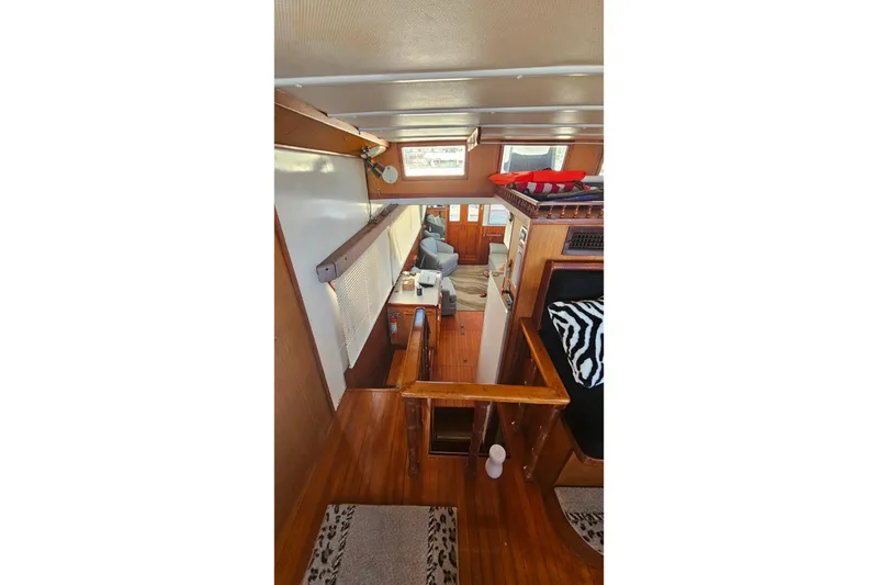 Slide: The Image of Interior of 1981 Sea Ranger 47 Pilothouse with wood paneling and cozy seating area. - 16