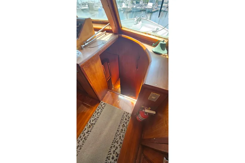 Slide: The Image of Interior of 1981 Sea Ranger 47 Pilothouse with wooden cabinetry and nautical decor. - 17