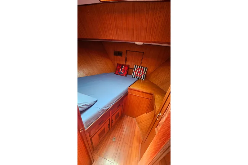 Slide: The Image of Cozy cabin interior of 1981 Sea Ranger 47 Pilothouse with wooden finish and blue bedding. - 22