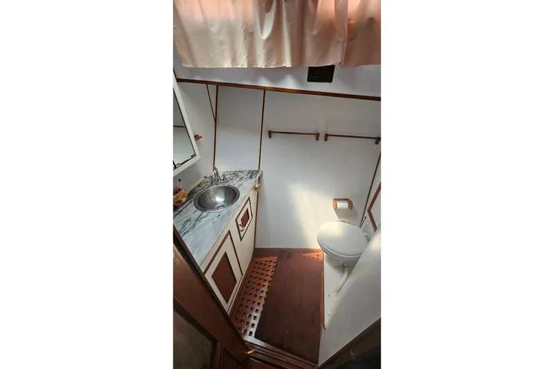Slide: The Image of Bathroom interior of 1981 Sea Ranger 47 Pilothouse with sink and toilet. - 23
