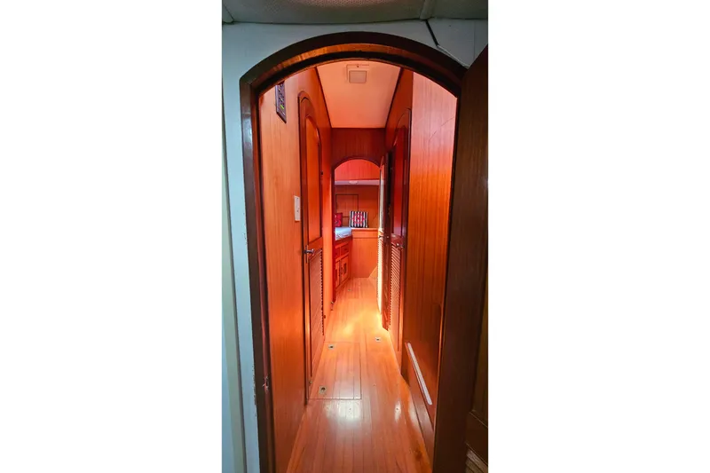 Slide: The Image of Interior hallway of 1981 Sea Ranger 47 Pilothouse with wooden paneling and warm lighting. - 24