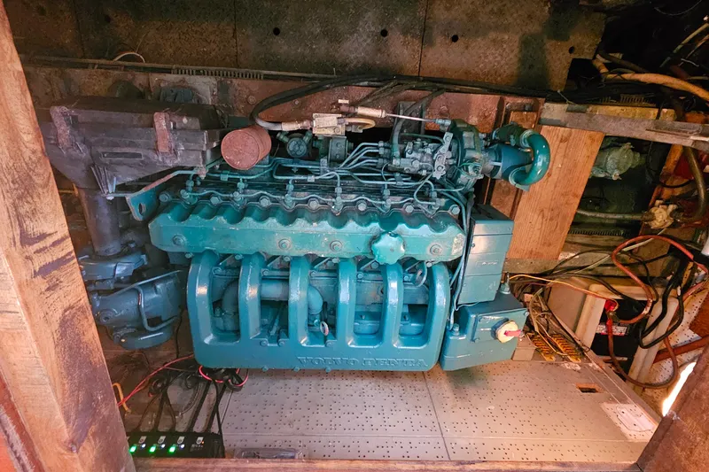 Slide: The Image of Engine compartment of a 1981 Sea Ranger 47 Pilothouse boat, showcasing a Volvo Penta engine. - 27