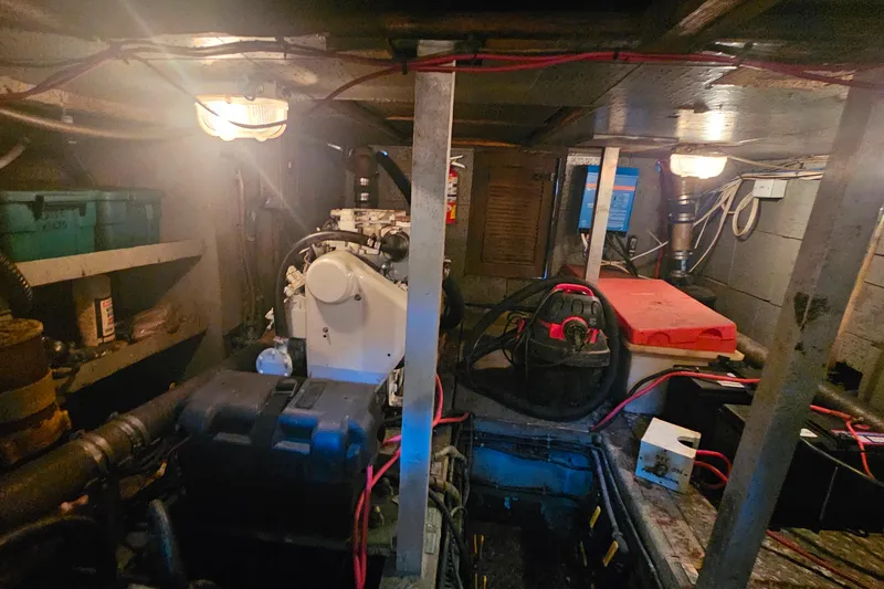 Slide: The Image of Engine room of 1981 Sea Ranger 47 Pilothouse with visible machinery and wiring. - 30