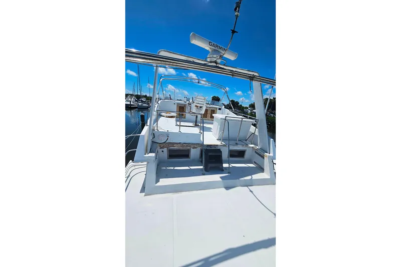 Slide: The Image of 1981 Sea Ranger 47 Pilothouse boat deck with clear blue sky background. - 33