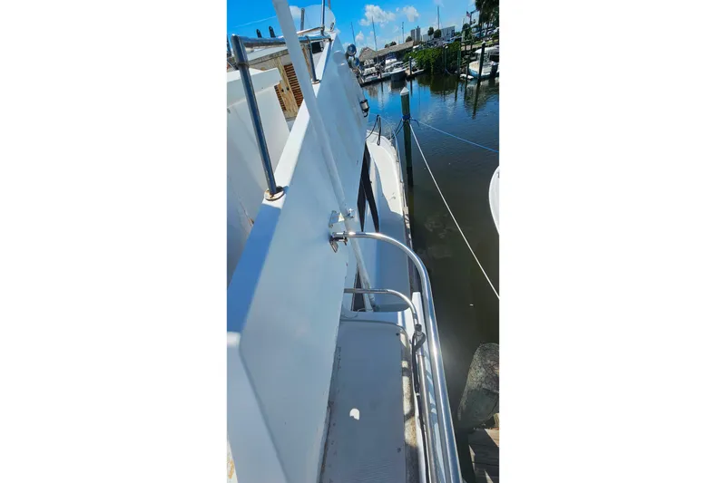 Slide: The Image of Side deck view of 1981 Sea Ranger 47 Pilothouse yacht docked at marina. - 37