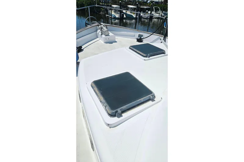 Slide: The Image of 1981 Sea Ranger 47 Pilothouse deck with hatches, docked near other boats. - 39